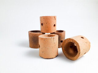 Mini clay pot isolated on white background, this pot is usually used for aquatic plants in aquascapes.