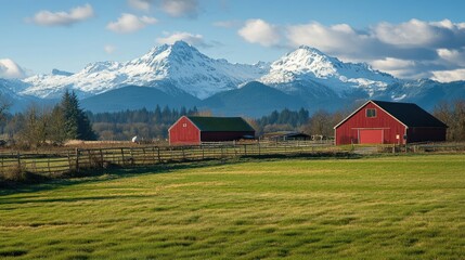 Obraz premium Tranquil grassland farm with majestic snow-covered mountains in the background, offering a serene and scenic view.