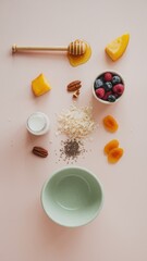 Fototapeta premium Breakfast Assortment with Oats, Yogurt, Berries, and Honey on Pink