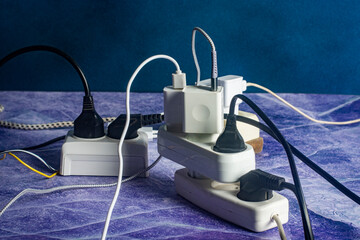 Close-up of many sockets, plugs and chargers.