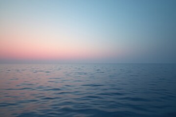 Obraz premium Serene sunset over calm ocean waves capturing tranquility and natural beauty.