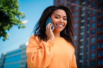 Photo of adorable sweet lady wear orange sweater communicating modern device walking outdoors urban...