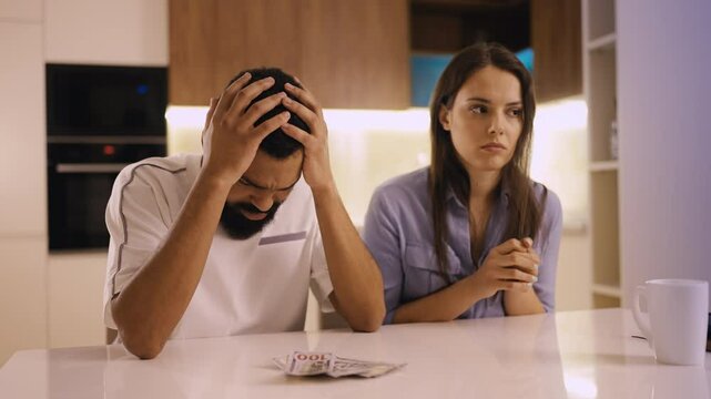Husband and his wife counting money, having not enough, financial crisis, debts