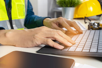 Construction and system engineers sit in their offices and draw up construction and system drawings.