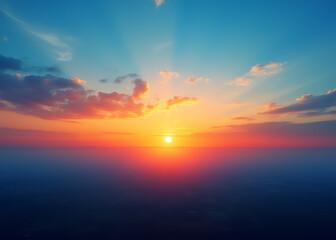 Fototapeta premium Vibrant colors blend in a beautiful morning sunrise over the landscape with blue and orange hues.