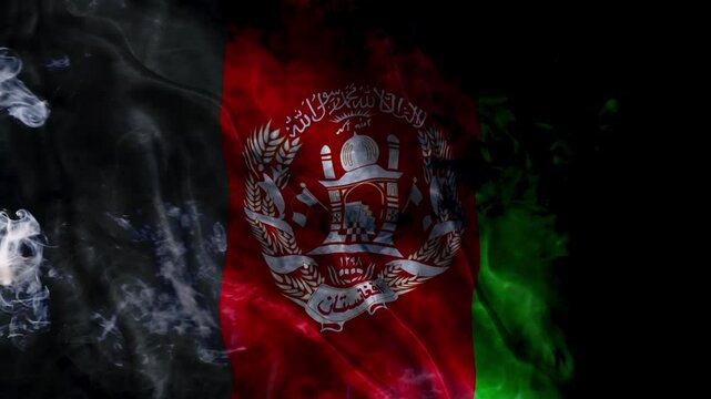 Waving the Afghanistan flag. Mysterious flag flying through the smoke. Afghanistan flag in fog