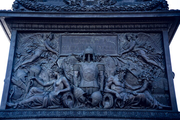 Detailed relief sculpture with classical figures and armor motif