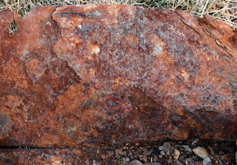 Detailed grungy texture of rusted metal plate. Rusty surface of brown and orange hues. Close-up of weathered old steel sheet with rust, chipped and peeling, aged iron, flaking paint, corrosion details