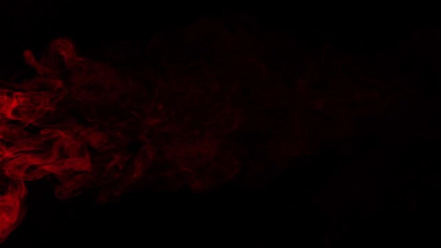 Red smoke texture isolated on dark background. Red smoke on black background