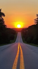 A serene view of a winding road surrounded by trees during sunset in the countryside