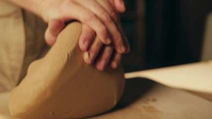 Man potter works with clay on master class in studio. Working process in ceramic workshop. Potter making vase on pottery wheel. Handmade concept. 