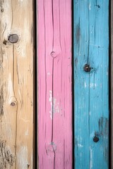 Three wooden boards in pastel tones, yellow, pink and blue, in vertical orientation background