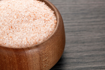 Himalayan pink salt in wooden bowl - Wood background