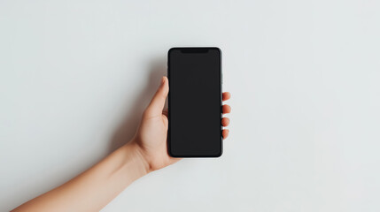 A hand securely holding a modern black phone 