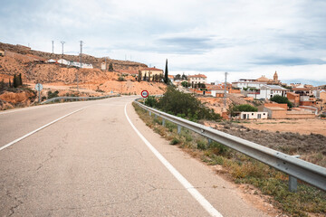 Naklejka premium A-224 paved road entering Urrea de Gaen, comarca of Bajo Martin, province of Teruel, Aragon, Spain