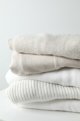 A stack of freshly washed, neatly folded clothing on a wooden table