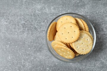 Delicious crispy crackers cookies on gray background