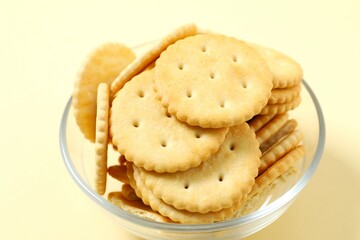 Delicious crispy crackers cookies on color background