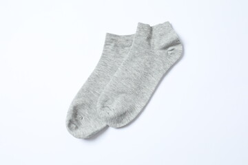 Gray socks on white background, flat lay. 