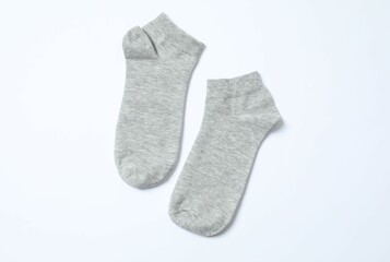 Gray socks on white background, flat lay. 
