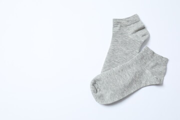 Gray socks on white background, flat lay. 
