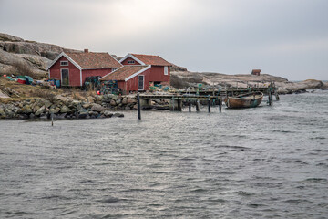 Beautiful village landscape in a fjord. Fishermen and restaurants in the evening at sunset. Boats and a beautiful landscape in Havstenssund, Sweden, Scandinavia