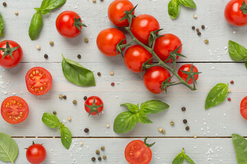 Fresh tomatoes, basil, sea salt and spices on wooden background, top view
