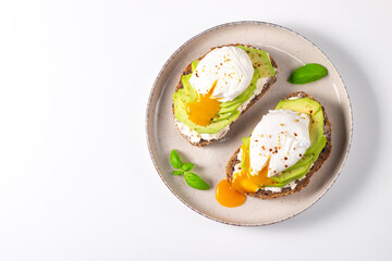 Two avocado open sandwiches with egg. Keto and diet concept. Healthy toast food for breakfast.