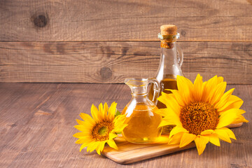 Closeup photo of sunflower oil with seeds on wooden background. Bio and organic product concept.