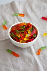 Halloween Sweet Fruit Gummy Worms in a Bowl, side view.