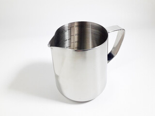 Stainless milk jug with measuring lines inside, isolated on white background