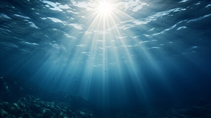 Obraz premium Underwater view of ocean surface, light beams shining through water