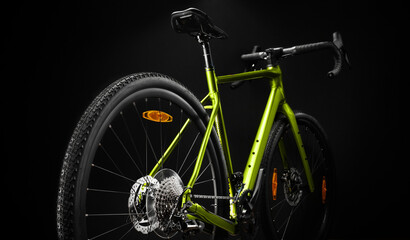 Rear view of a gravel bike with modern design, set against a black background. Ideal for cycling promotion.