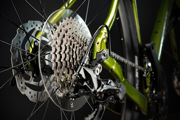 Gravel bike transmission. Rear derailleur, cassette with sprockets, chain, frame. Close-up shot.