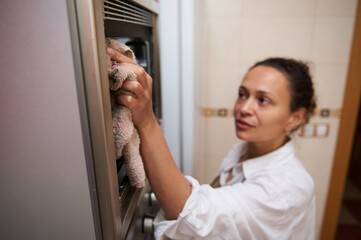 Woman performs household cleaning with diligence and care