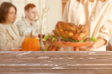 Empty table and friends having dinner on Thanksgiving Day