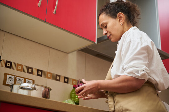 Woman preparing a meal in a modern kitchen setting