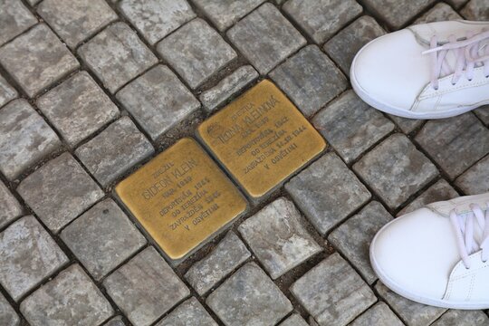 PRAGUE, CZECH REPUBLIC - MAY 5, 2024:  Stolperstein brass cubes commemorating Jewish victims of Holocaust and Nazi terror of World War 2 in Prague.