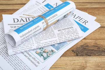 Daily newspapers on wooden background