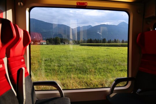 CARINTHIA, AUSTRIA - AUGUST 7, 2022: Window view fromt passenger train of Austrian Federal Railways OBB near Hermagor-Pressegger See in Carinthia, Austria.