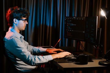 Working IT developer concentrating online software development information on surrounded by coding application pc screens, creating program for firmware on website at neon modern office home. Gusher.