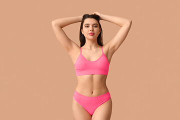 Obraz premium Attractive young woman in sexy lingerie on color background