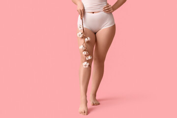 Beautiful young woman with cotton flowers on pink background, closeup