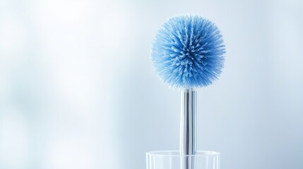A blue cleaning brush with a round head, designed for effective scrubbing.