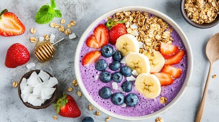   A bowl of oatmeal with strawberries, bananas, and blueberries sits beside a bowl of granola