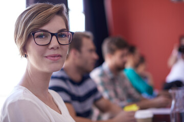 Office, business woman and meeting in portrait for listening, workshop and feedback in creative agency. Boardroom, professional career and employees with training for startup update, progress and job