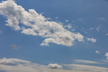 Fototapeta premium Serene sky with fluffy white clouds on bright sunny day, peaceful nature backdrop, cloudscape tranquility concept