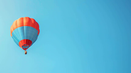 Fototapeta premium Hot air balloon ride over the countryside. The balloon is red, orange, and blue, and is flying high in the sky.