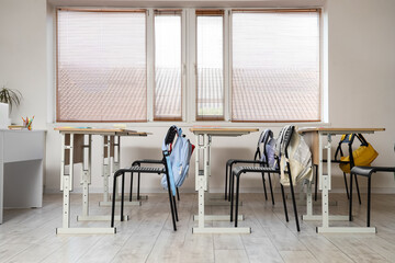 Interior of empty classroom with school desks