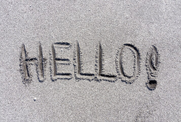 Business hello and welcome concept. Concept word Hello written on beautiful ocean sand beach. Beautiful ocean sand beach background, copy space. Business hello and welcome concept. © Dzmitry